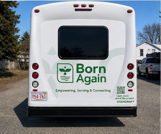 Rear of the Born Again bus with the logo and tagline